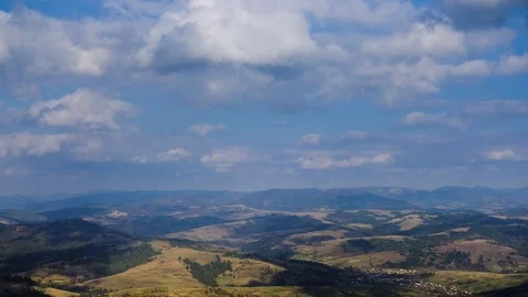 Time lapse of blue sky with clouds over mountain hills. Autumn sunny day land Stock Footage 120791206