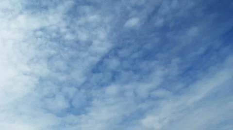 Time lapse of blue sky with fast moving clouds. Loopable Stock Footage