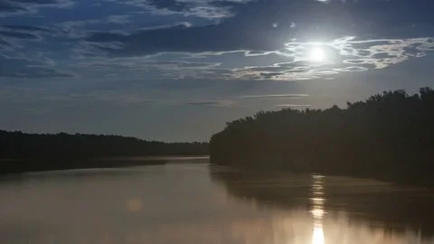 Time lapse of blue sky with flowing clouds reflecting in calm foggy river with Video stock 75327362