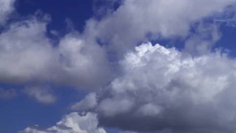 Time-lapse of blue sky serves as the backdrop for the dance of these white .. Stock Footage 336740965