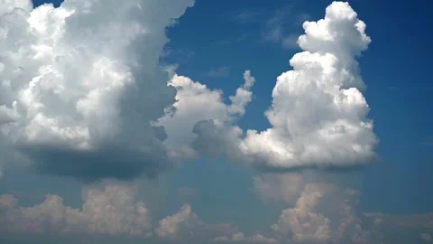 Time lapse of bluish gray and white thunderstorm clouds building in blue sky Stock Footage 290438044