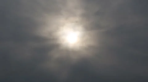 Time lapse of blurred sun hiding behind storm clouds Stock Footage 59159008