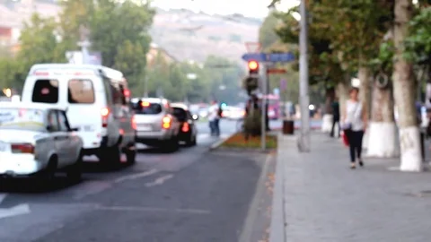 Time lapse blurred vehicles, blurred people cross the road, against the Stock Footage