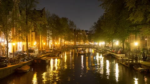 Time Lapse -  Boat Cruising Down Canal at Night  - Amsterdam Netherlands Stock Footage 58461047