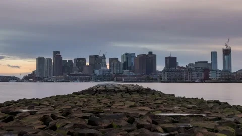 A time-lapse of Boston skyline from La Presti Park, going from sunset to Stock Footage 167998046