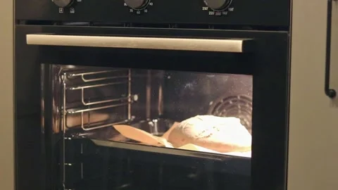 Time lapse of the bread rises in the oven as it bakes. Food Stock Footage 298058876