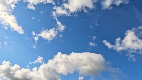 Time lapse of bright clouds moving across blue summer sky Stock Footage 322657933