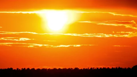 Time Lapse Bright Orange Sunset Sun Sets Behind the Clouds Stock Footage 215799542