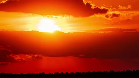 Time Lapse Bright Orange Sunset Sun Sets Behind the Clouds Stock Footage 218156982