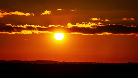 Time Lapse Bright Orange Sunset Sun Sets Behind the Clouds Stock Footage 229545724