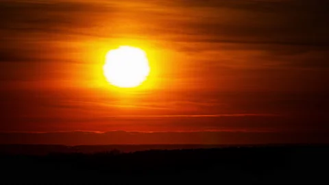 Time Lapse Bright Orange Sunset Sun Sets Behind the Clouds Video stock 230086055