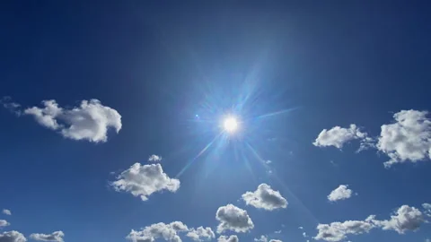 Time-lapse of bright sun shining in clear blue sky with moving white cumulu.. Stock Footage 346438226