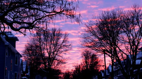 Time lapse: Bright sunset over a snowy residential street framed by trees Stock Footage 34335217