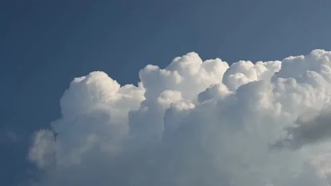 Time lapse of bright white churning clouds in a blue sky before a storm Stock Footage 205466274