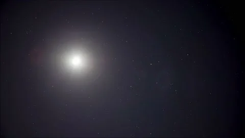 Time lapse: brightly shining moon and stars in night sky 4K Stock Footage 131005505