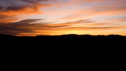 Time Lapse-Brilliantly lit cloud move slowly and darken as sun goes down Stock Footage 117576384