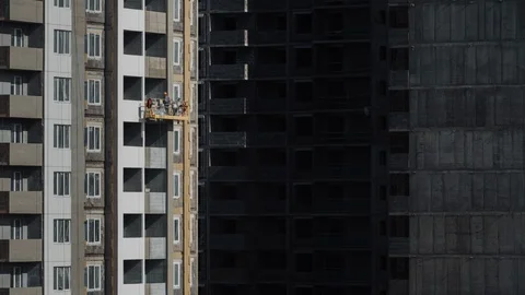 Time lapse builders work on suspended cradles at construction site Stock Footage 129567036