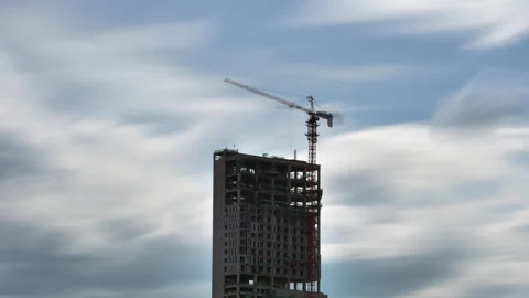 Time-lapse of building construction under motion blurred smooth clouds Stock Footage 346561954