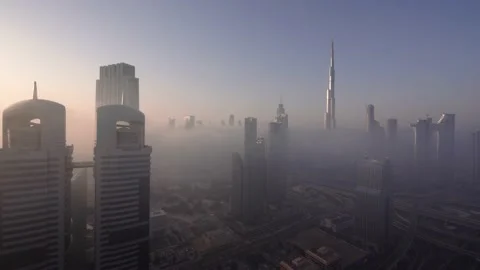Time Lapse of Burj Khalifa covered in a sea of fog at dawn Stock Footage 222572846