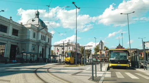 Time lapse of bus and tram stop on brigth summer day. Trams and buses moving at  Stock-Footage 135900581