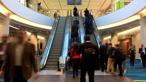 Time lapse of business people taking indoor escalator at conference center Stock Footage 88563984