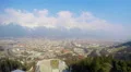 Time-lapse of busy city near mountains, popular ski resort, aerial pan, travel 4k or 4k+ Resolution