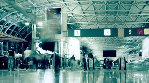 Time lapse of a busy crowded generic airport terminal. Long exposure motion blur Stock Photos