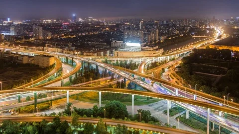 Time lapse of the busy interchange traffic at night in city Stock Footage 77919051