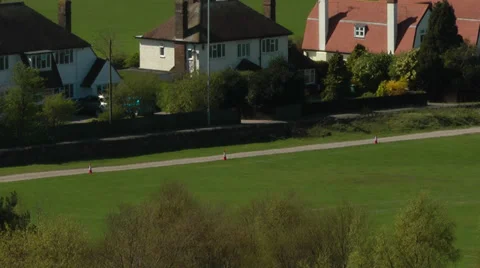 Time lapse of busy traffic passing by countryside houses Stock Footage 37109573
