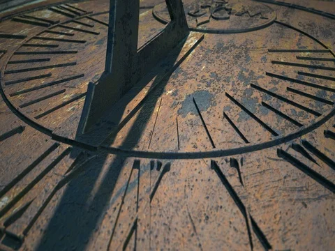 Time-lapse of a camera panning across a metal sundial Stock Footage