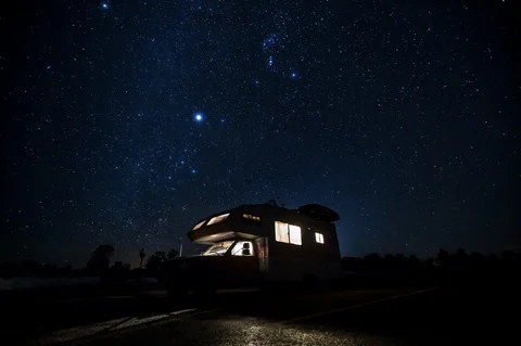 Time-lapse of camper van parked and Constellations in the sky at night Stock Footage