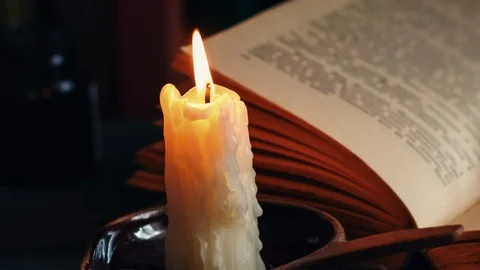 Time lapse candle and old books at night time. Close up view. Stock Footage 94608491