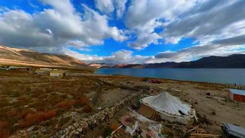 Time lapse of Captivating Clouds over Pangong Lake with Sun Rays and Mountain Ra Video stock 237985498