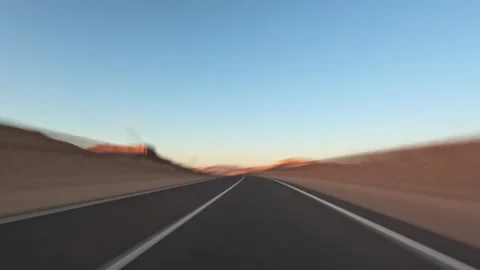 Time lapse car driving with fast speed on desert road with blurred rocky Video stock 326023567