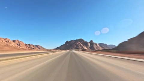 Time lapse car driving through desert canyon road with rocky slopes and blue sky Stock Footage 326023620