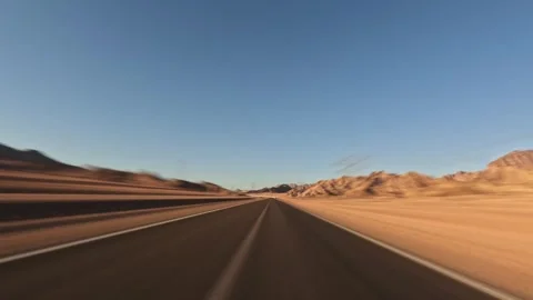 Time lapse of car driving through desert canyon road with rocky slopes on Video stock 326025127