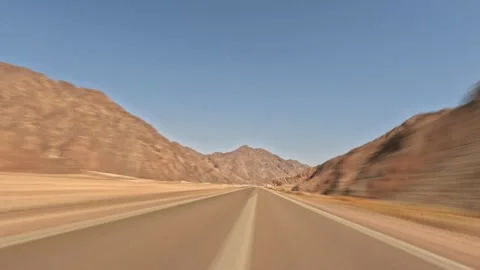 Time lapse car fast driving on empty desert road through rocky mountains at Stock Footage 340866885
