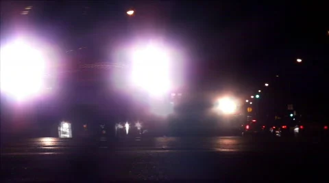 Time-Lapse of Car Headlights Turning Through City Intersection at Night Stock Footage 514121