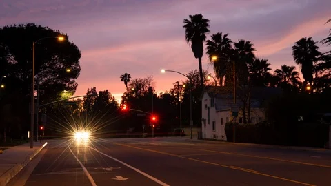 Time lapse of car light streaks at a Pasadena intersection on a colorful sunset Stock Footage 127544659