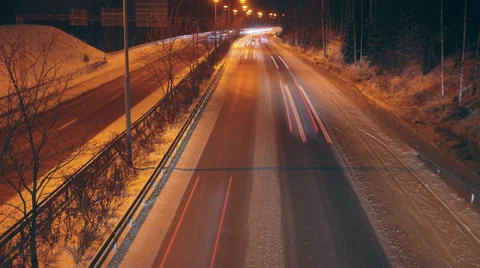 Time lapse of car light trails on a snowy highway Video stock 69032730