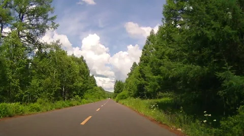 Time Lapse: A car runs through a national  park under blue sky with white clouds Stock Footage 40743664