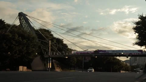 Time-lapse of car traffic on street at rush hour at sunset with moving clouds Stock Footage 244591123