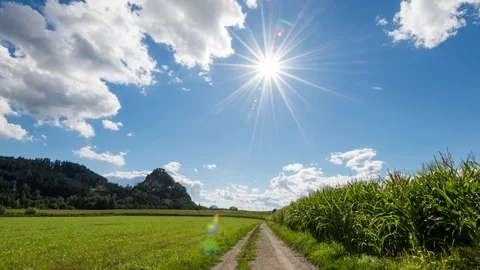 Time Lapse - Castle with a corn field in front and moving clouds above Stock Footage 99362913