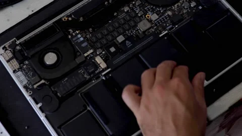 Time lapse: caucasian technician opens and repairs or cleans a laptop. Top view Stock Footage 135669598