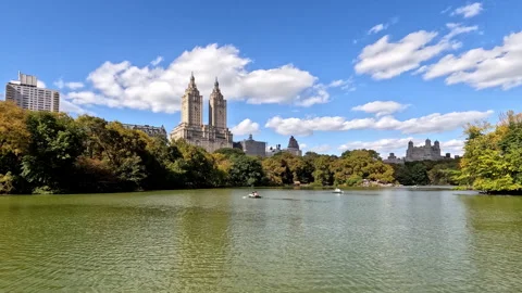 Time Lapse Central Park boating scene with iconic buildings, lush greenery, and Stock Footage 293366796