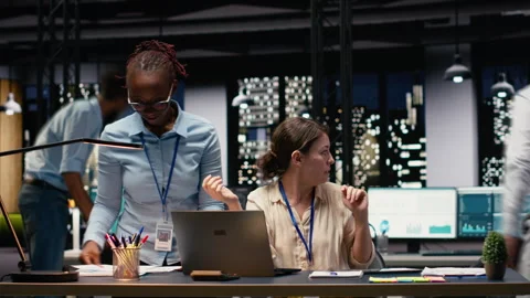 Time lapse of CEO and staff analyzing data together in office late at night Stock Footage 334043827