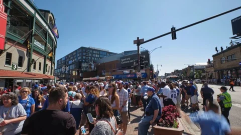 This is a time lapse of Chicago Cubs fans getting ready to enter Wrigley Stock Footage