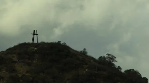 Time lapse of a Christian Holy Trinity symbol on hill against a blue cloudy sky Stock Footage 45581977