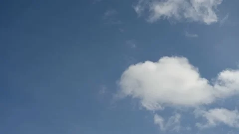 Time lapse of churning white clouds in a bright blue sky. Stock Footage 153117815
