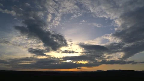 Time lapse of cinematic mystical sunset over partly cloudy sky - Plains Sunset Stock Footage 339365895